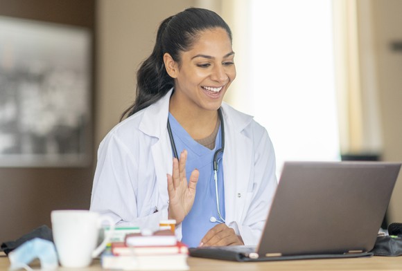 Physician consulting with a patient using Teladoc's virtual platform.