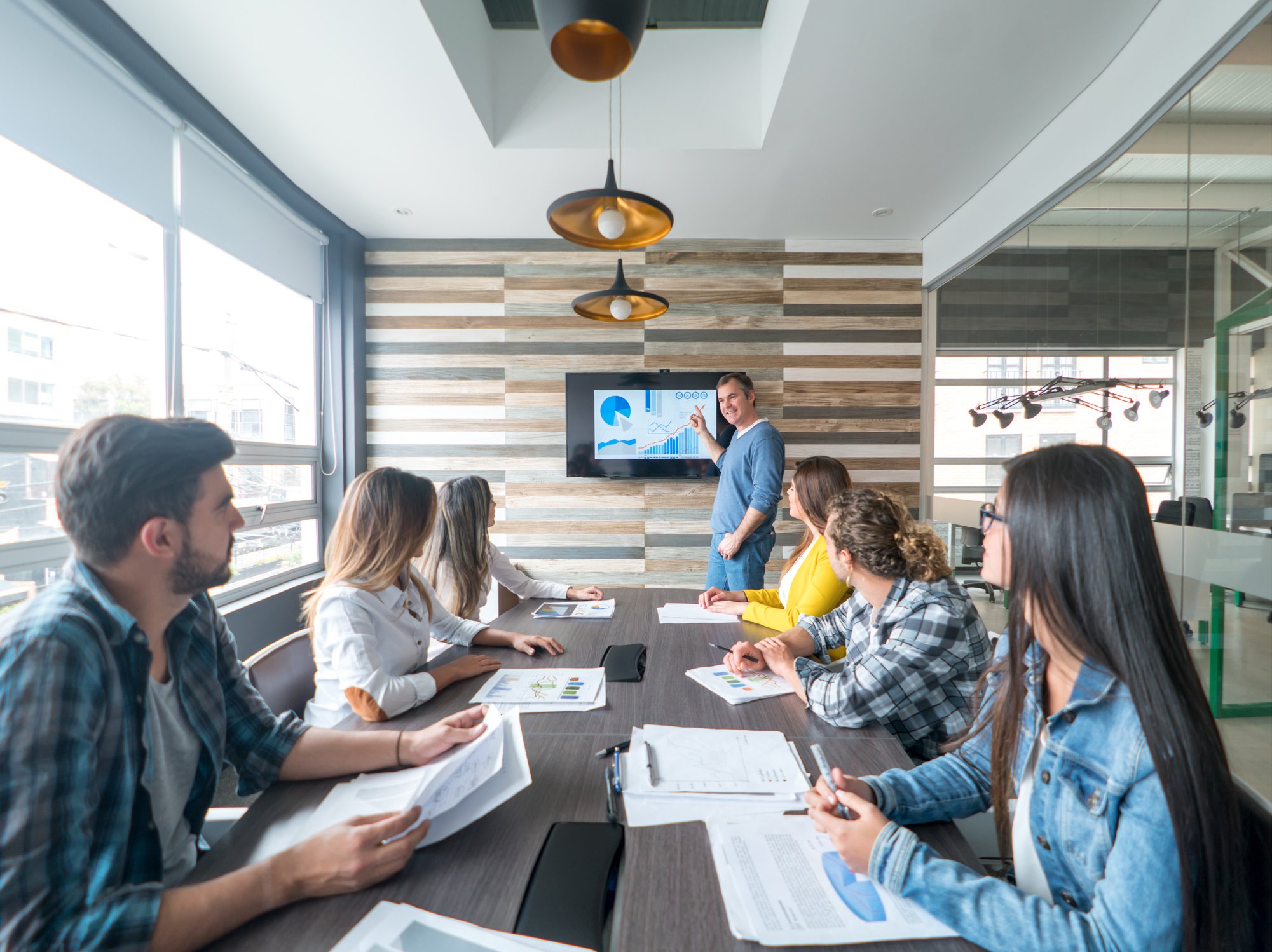 Person delivering a presentation at a meeting.