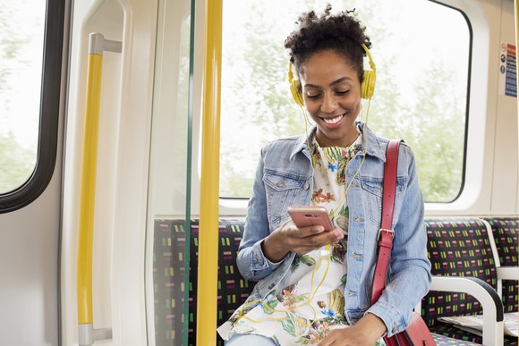 A person listening to music on a bus.