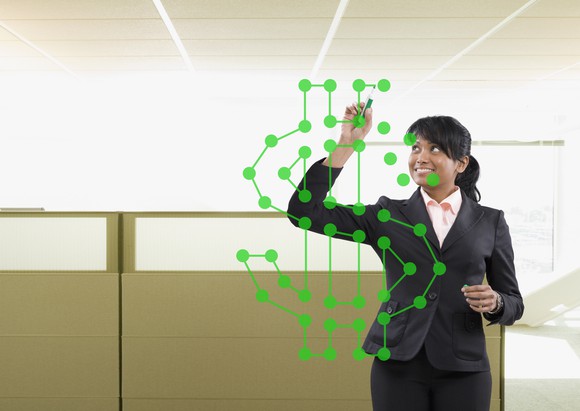 Person drawing a dollar sign