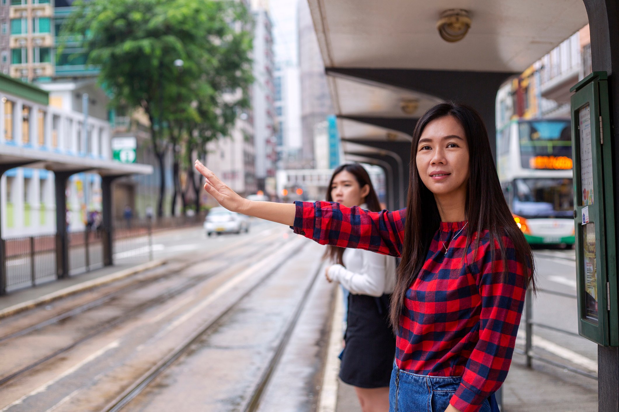 A person hails a cab.