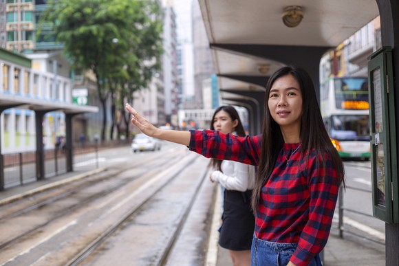 A person hails a cab.