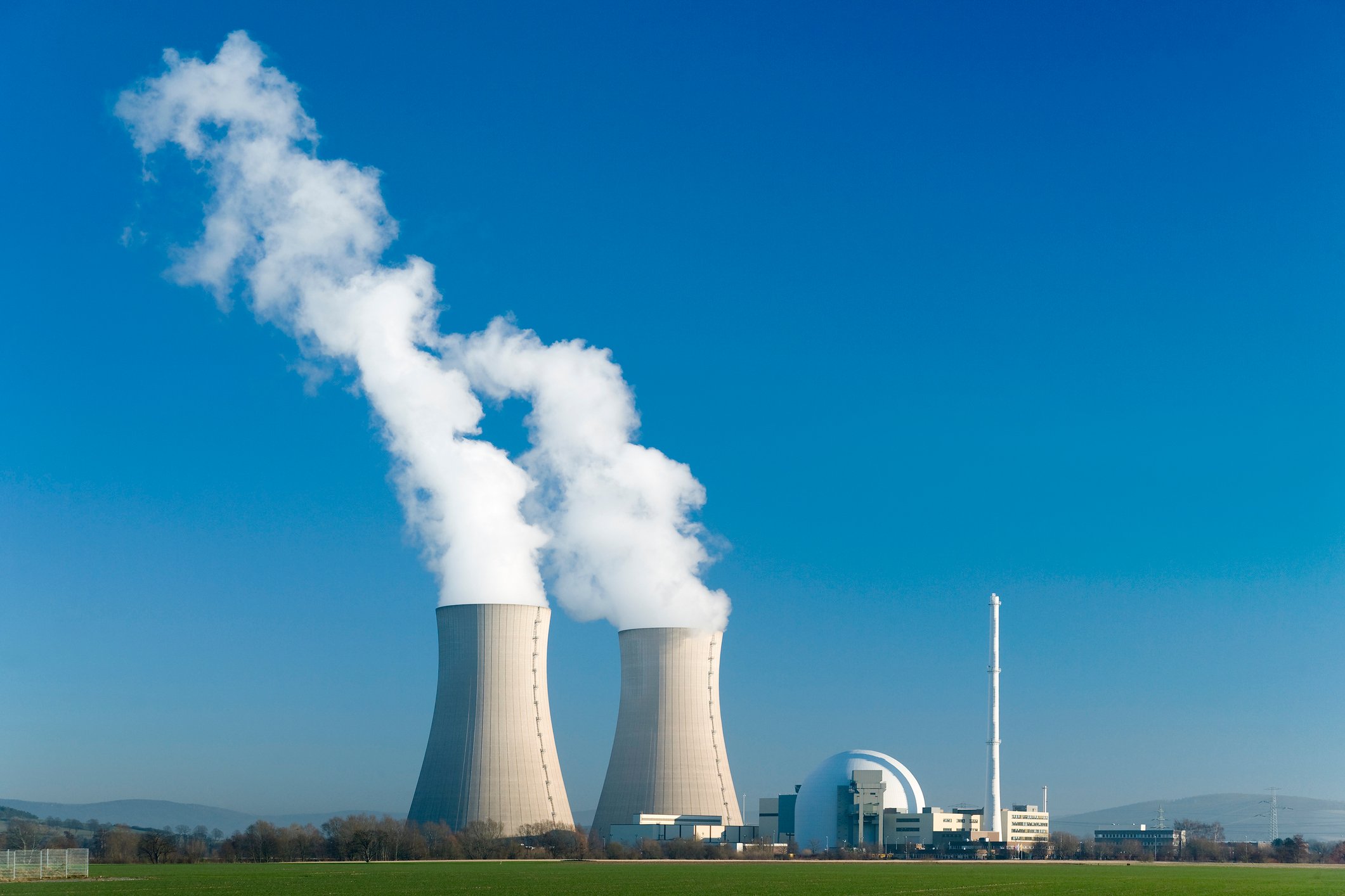 Steam rising from a pair of nuclear reactor cooling towers.