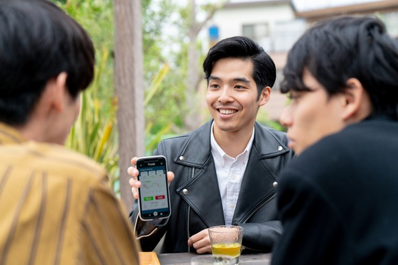 Young man explaining his investment to his friends.