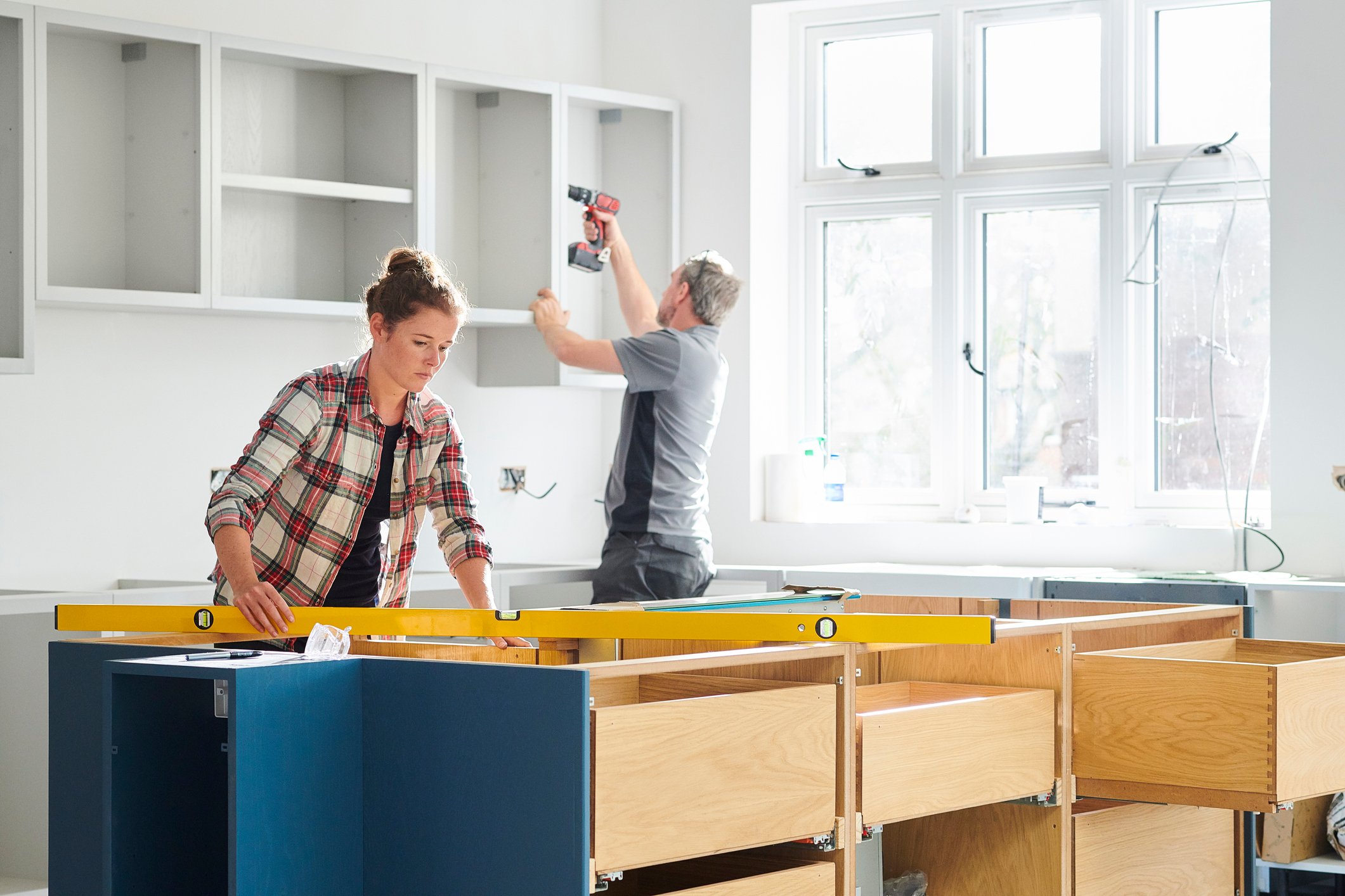 Two people working on a home-improvement project.