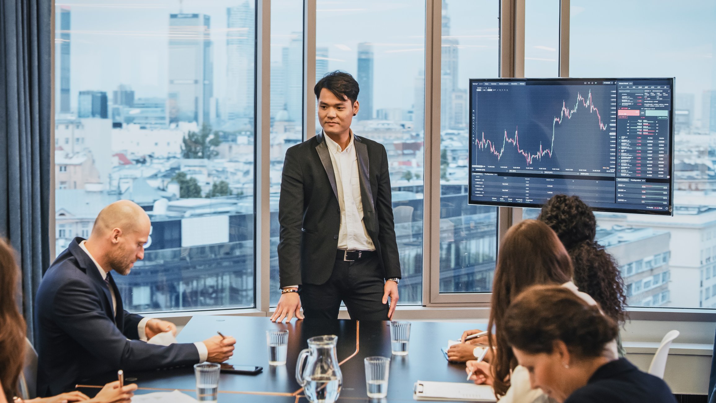 A person gives a presentation to co-workers in a conference room.