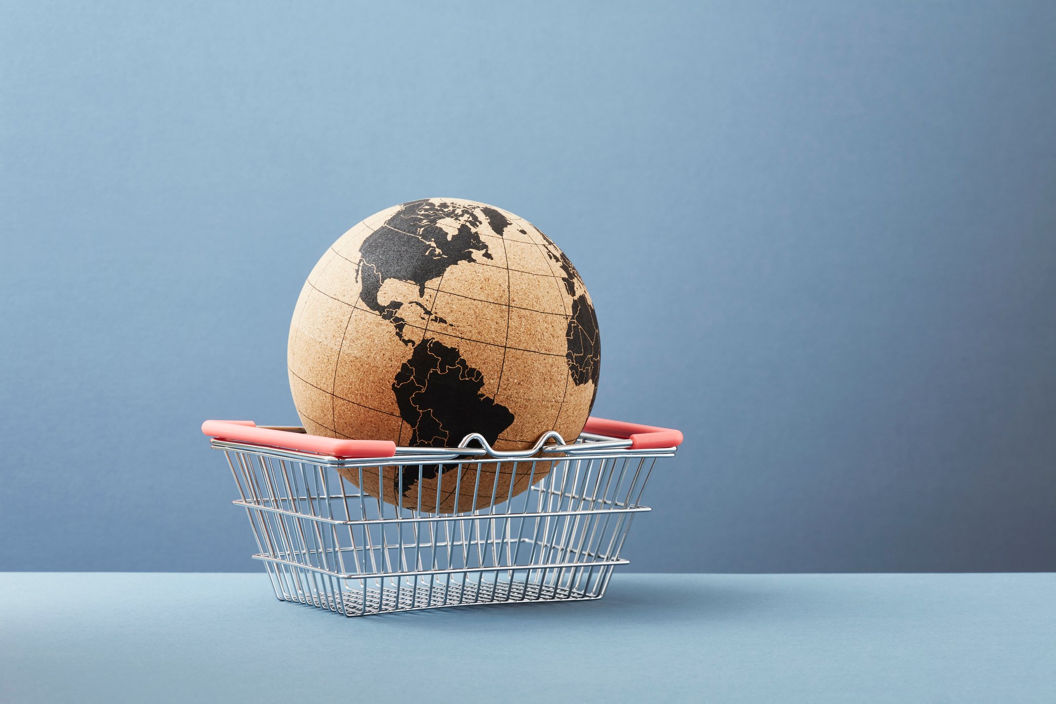 A globe sitting in a shopping basket.