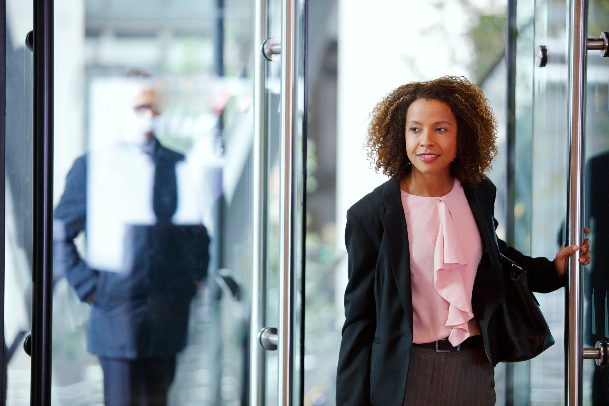 A business woman on the move, leaving her office building. 