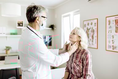 Doctor conducts physical exam on elderly woman
