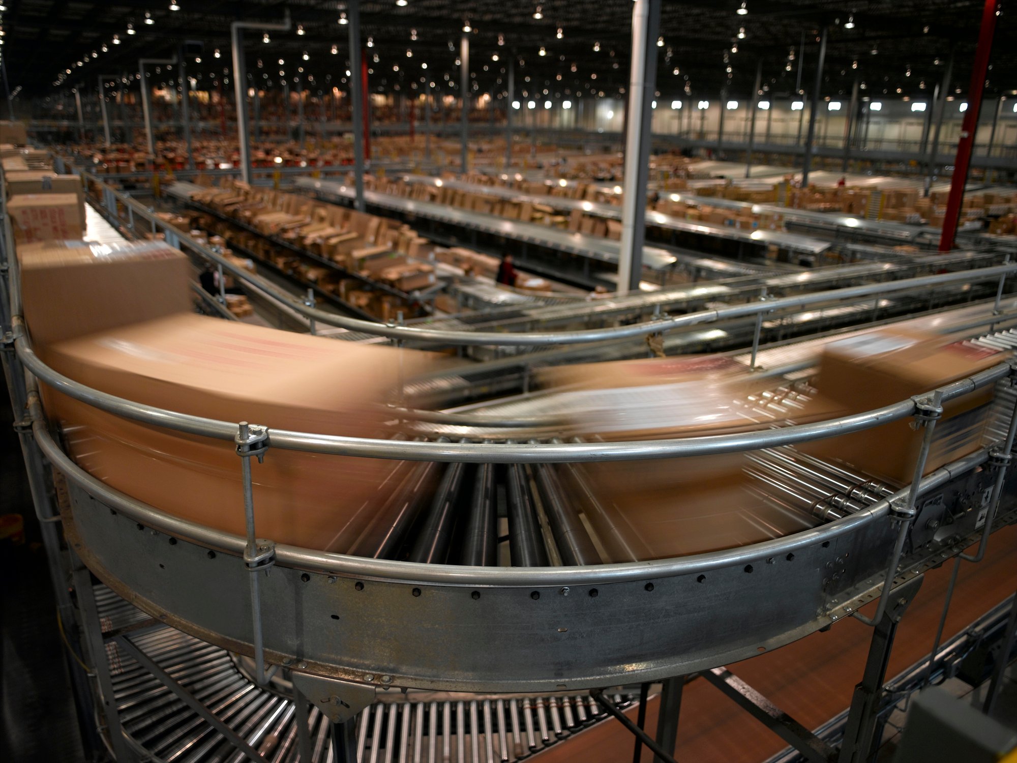 Packages flying by on high speed conveyor.