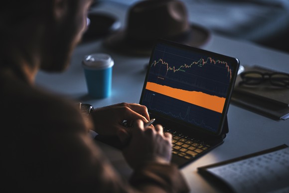 A person checking cryptocurrency prices on a laptop. 