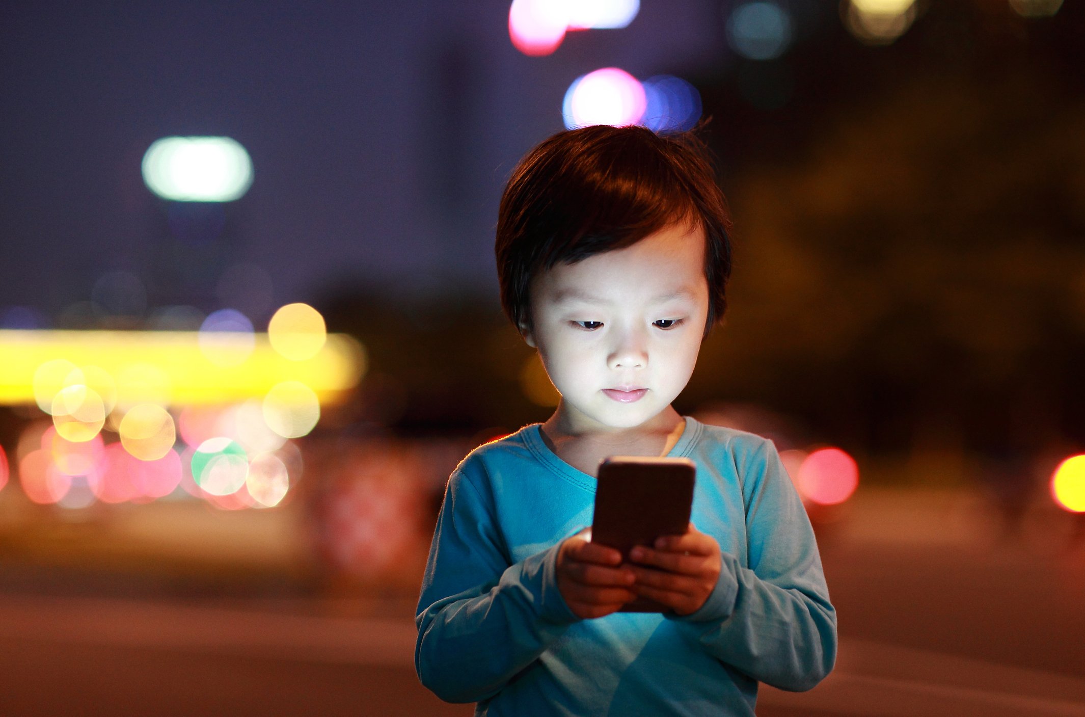 A child uses a smartphone.