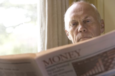 Senior Reading Financial News Investing Getty