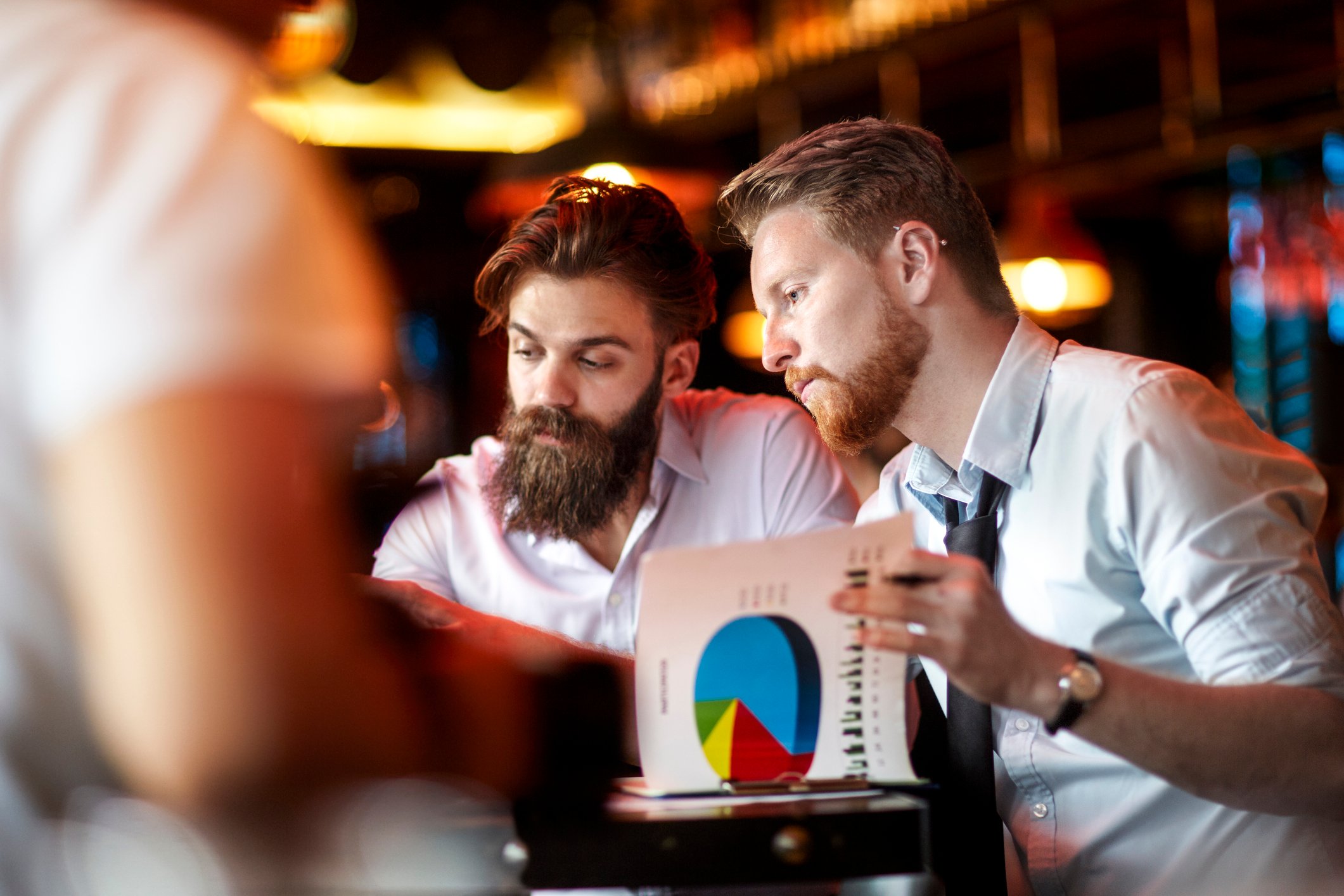 Investors evaluating growth charts and stock data.