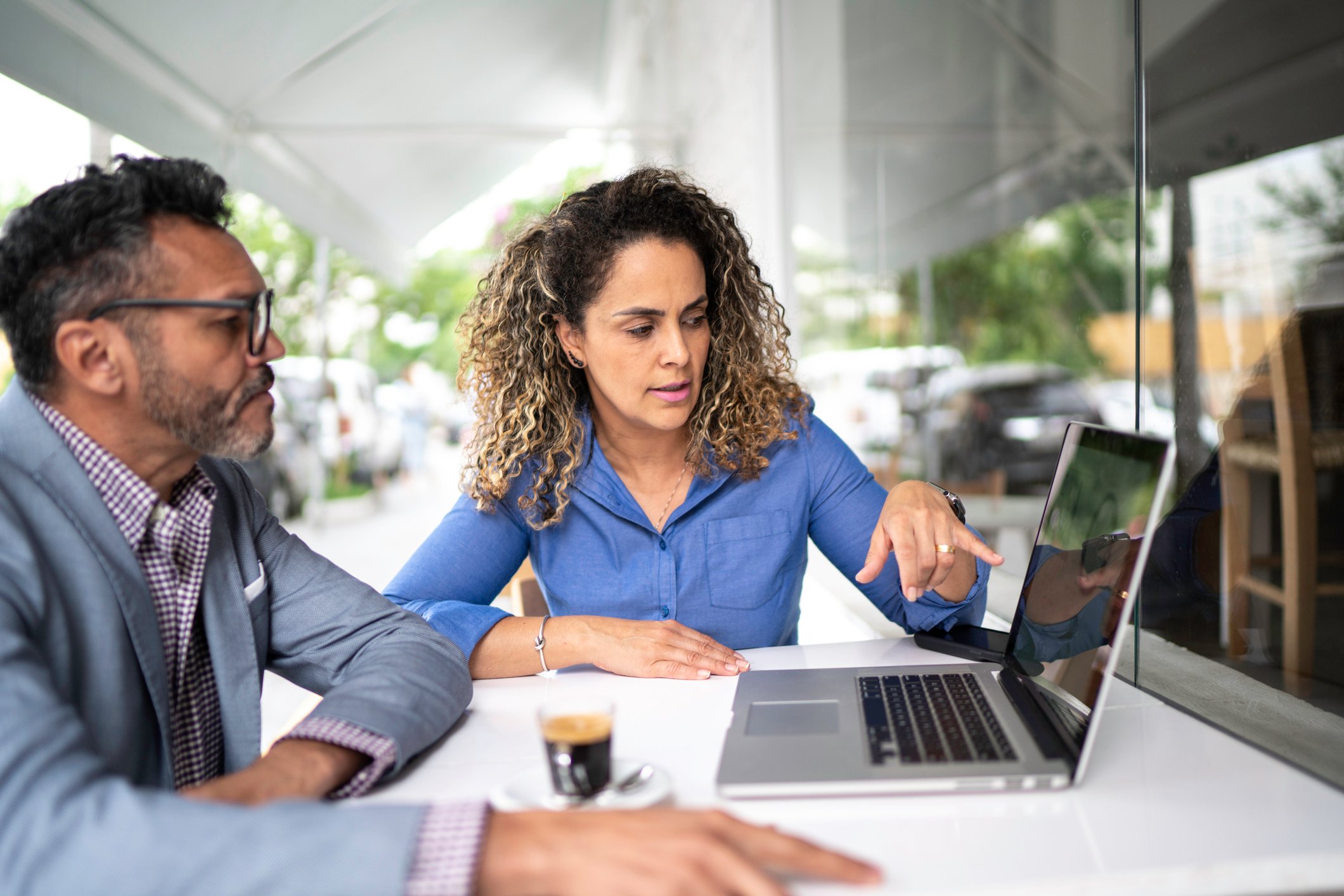 two business people looking at data on computer screen