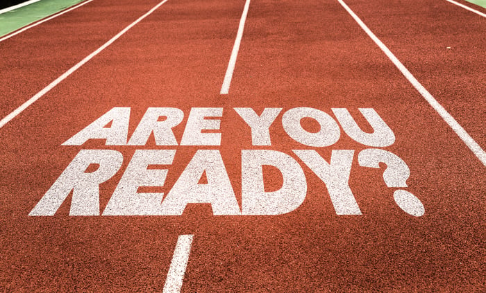 The words are you ready are on a running track's surface.