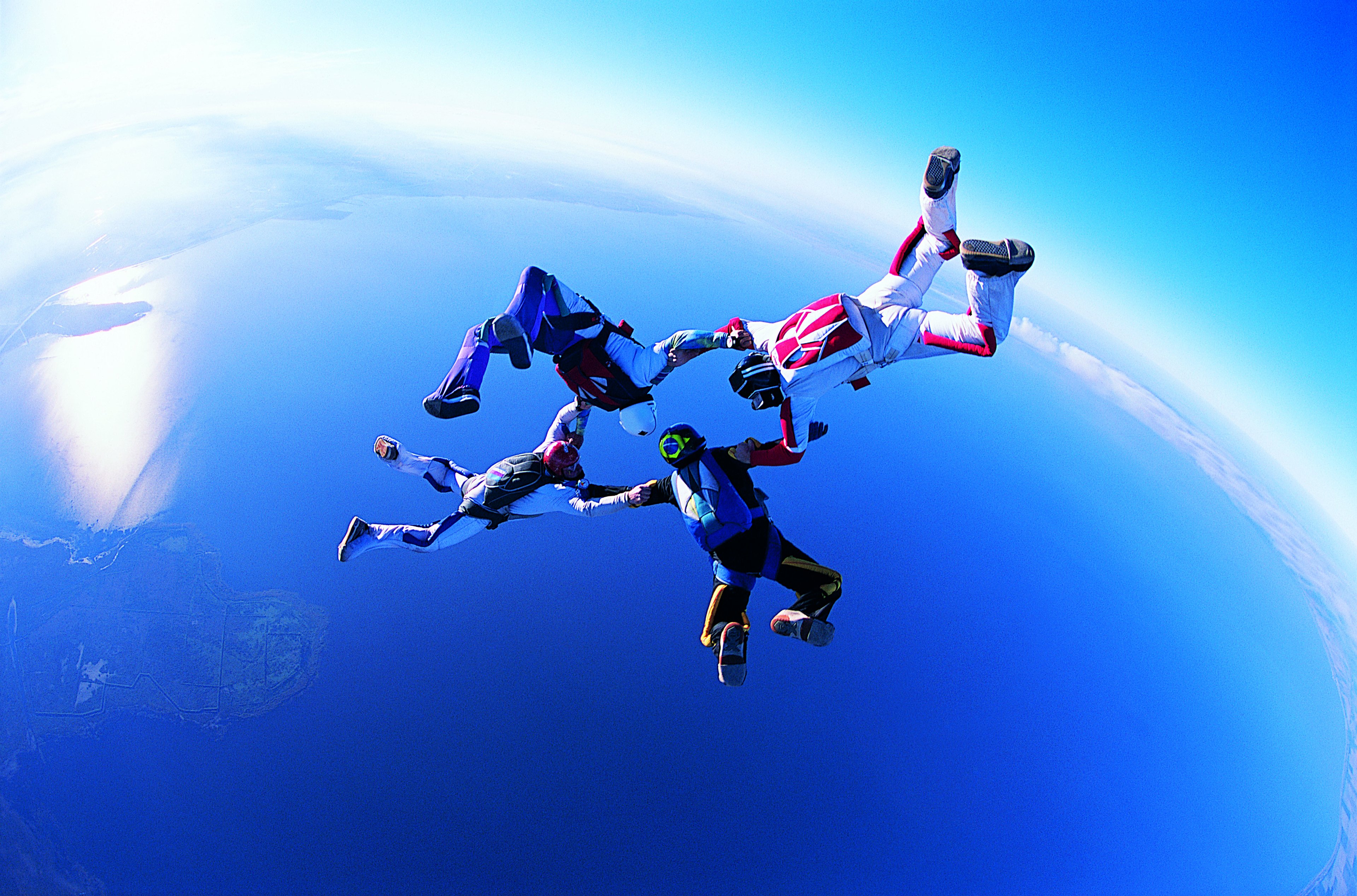 A group of four people on a tandem skydive.