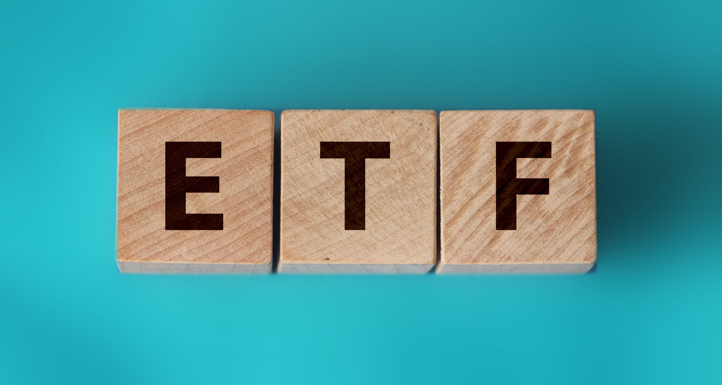 Wooden blocks spelling out "ETF."