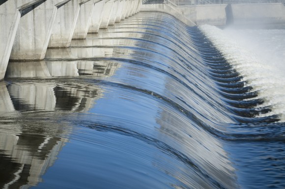 Water flowing over a dam. 