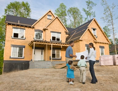 family in front of house construction getty 1