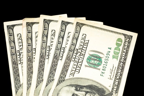 Hundred-dollar bills on a black background.