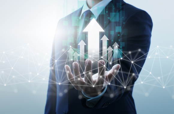 Arrows rising upward from an investors outstretched palm.