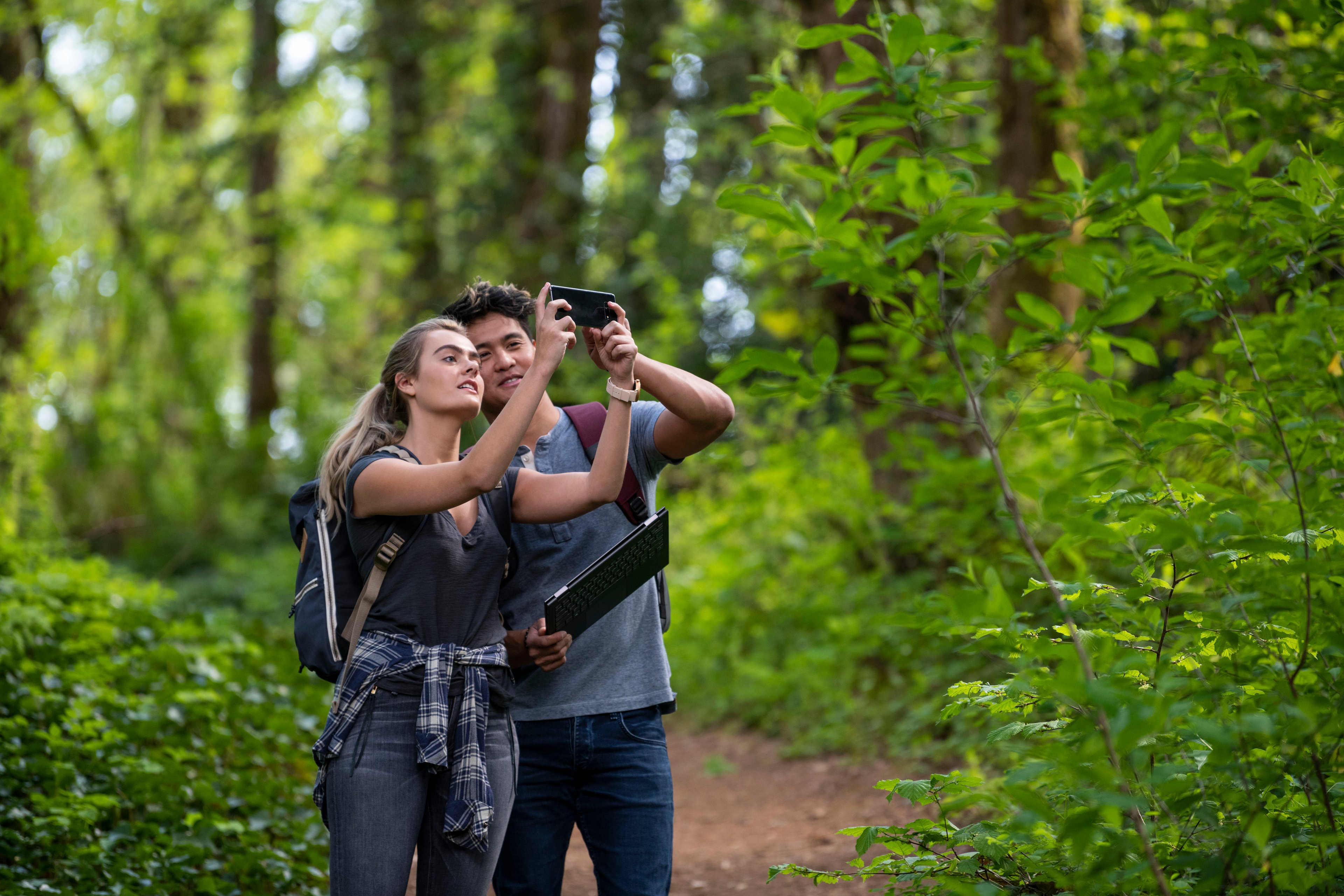 Couple exploring the wilderness with a connected mobile device.