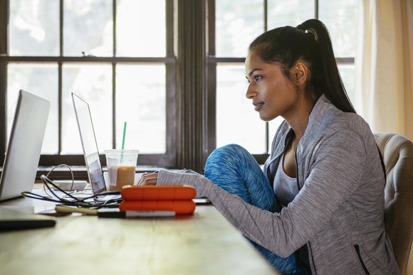 A woman wearing athletic apparel while working from home.