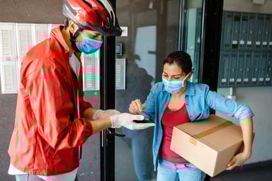 Lady Receiving Parcel from Delivery Guy