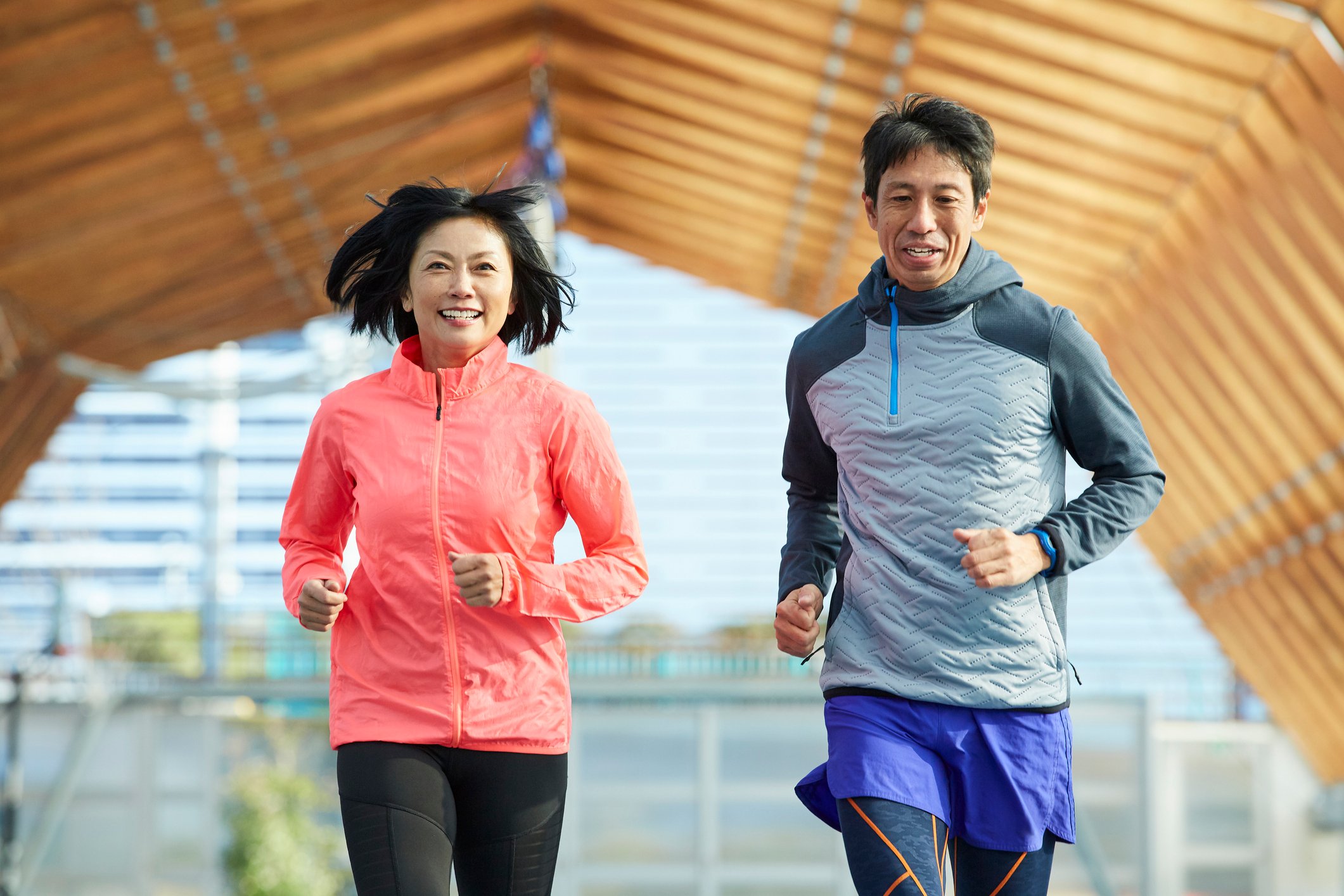 Two people jogging outside.