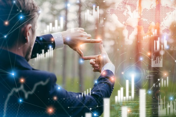 Person reviewing financial charts on a virtual display.