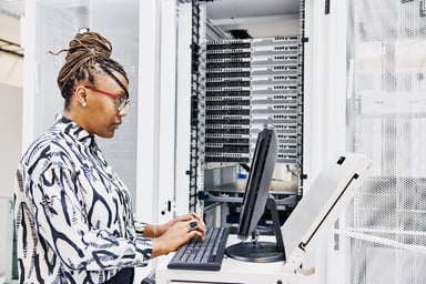 Employee works on a monitor inside a data center.