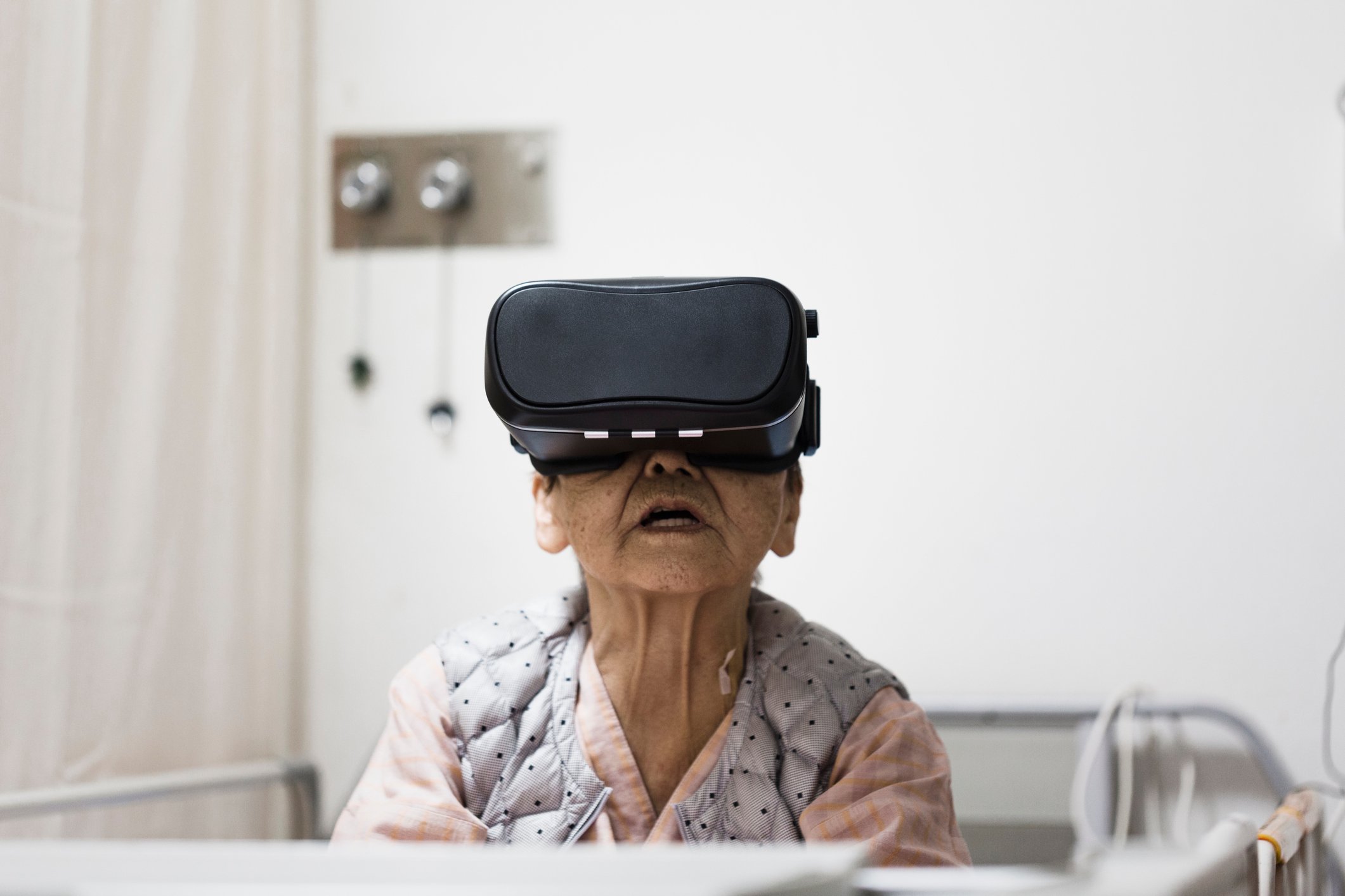 Senior citizen wearing a VR headset.