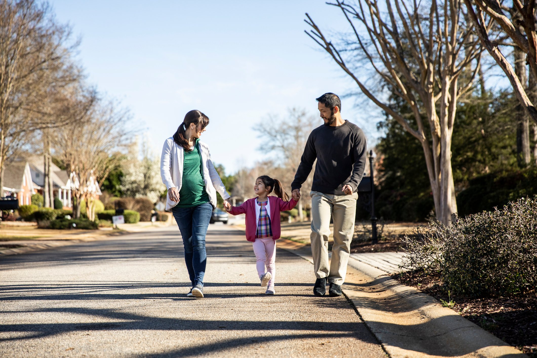 Family walking in a neighborhood.
