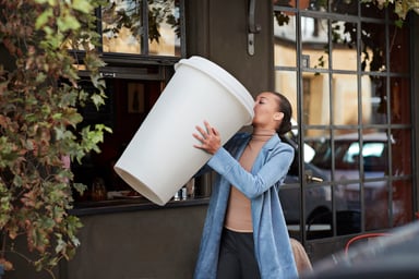 woman drinking giant cup of coffee