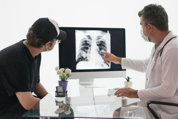 A doctor explaining a chest x-ray to a patient.