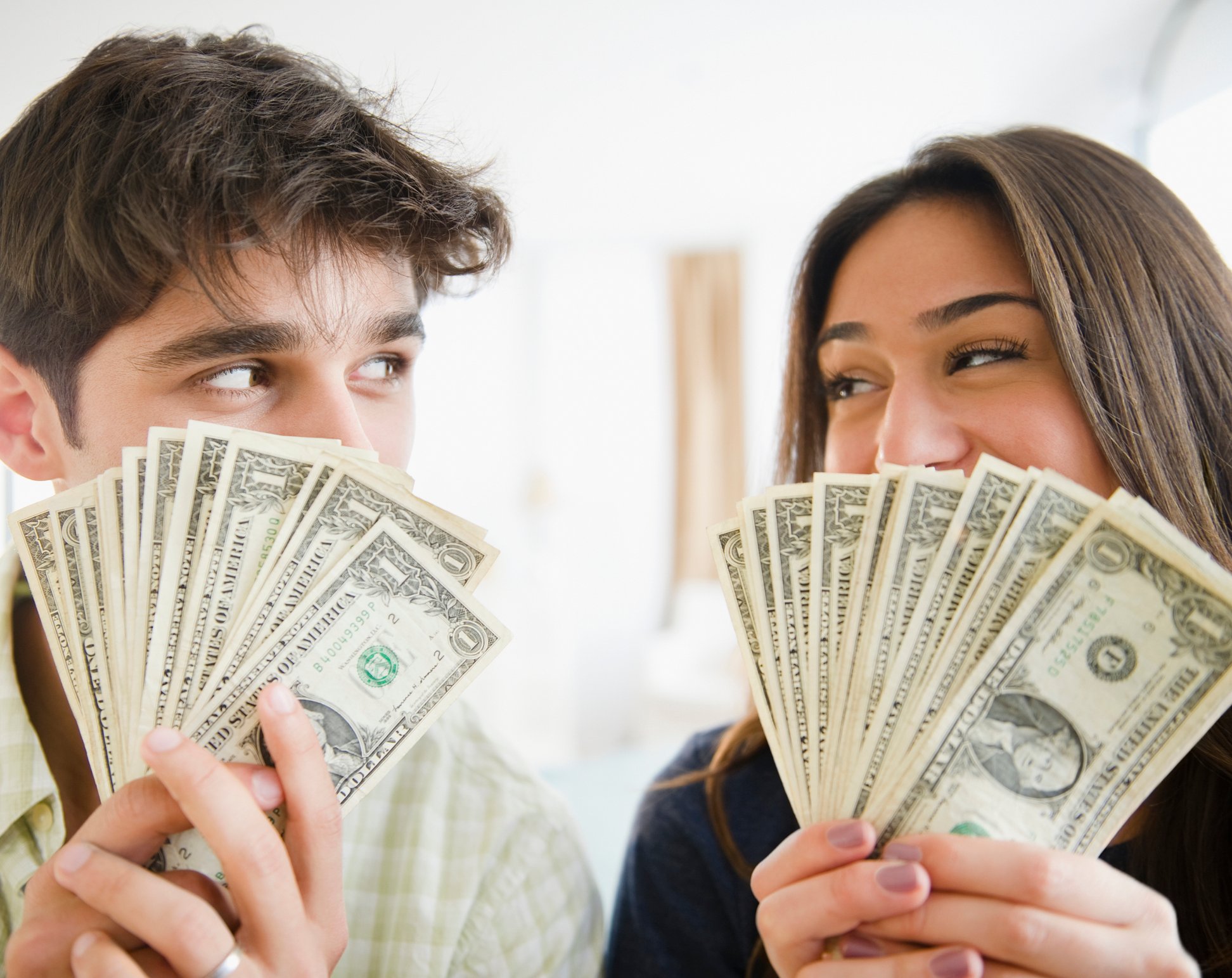 Two people with fans of 1 dollar bills