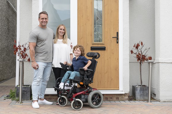 A family outside of their front door.