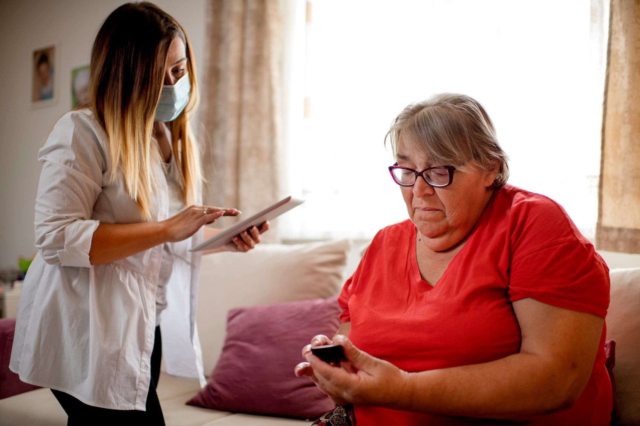 Doctor checking up on patient in a private residence. 