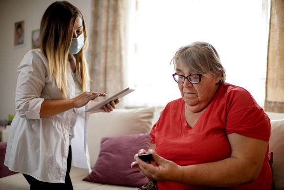 Doctor checking up on patient in a private residence. 