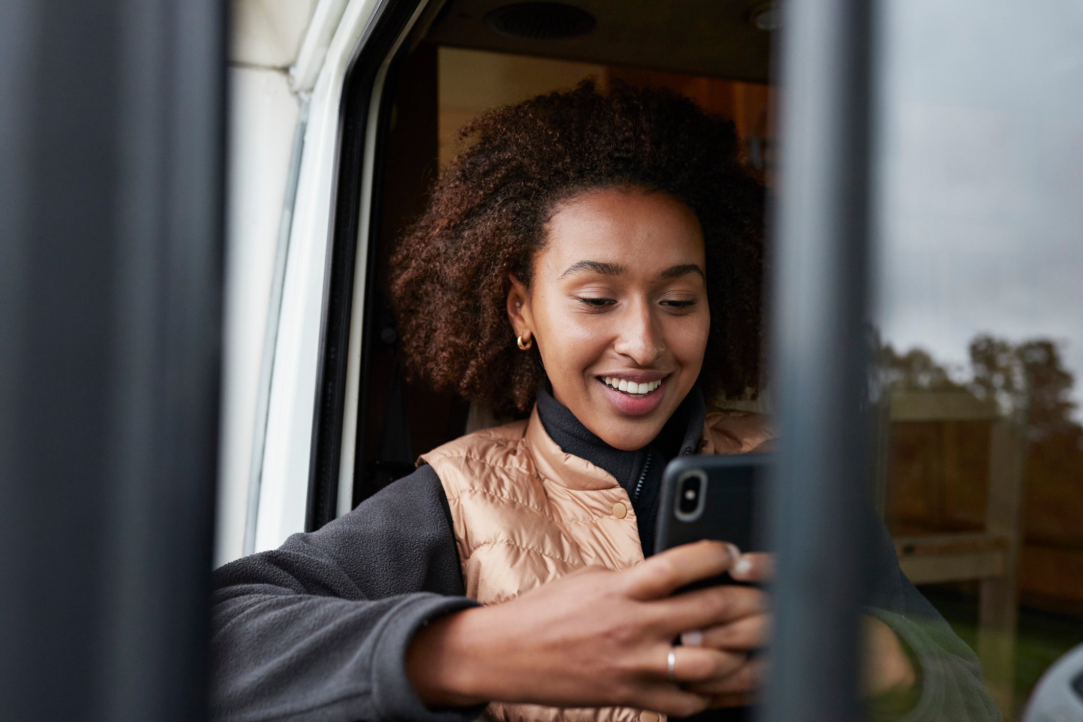 Person happily engaging with smartphone.