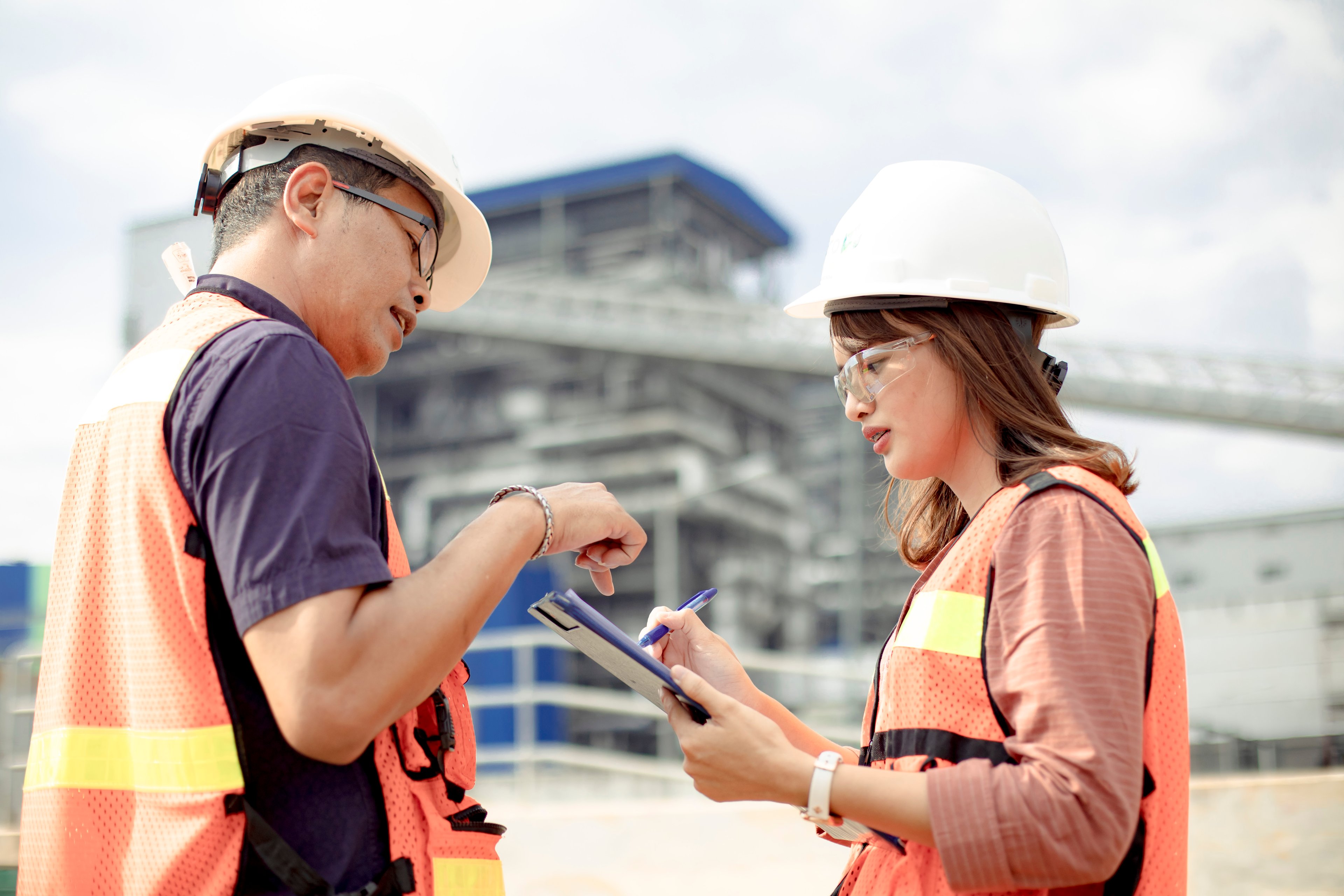 Workers looking at a tablet.