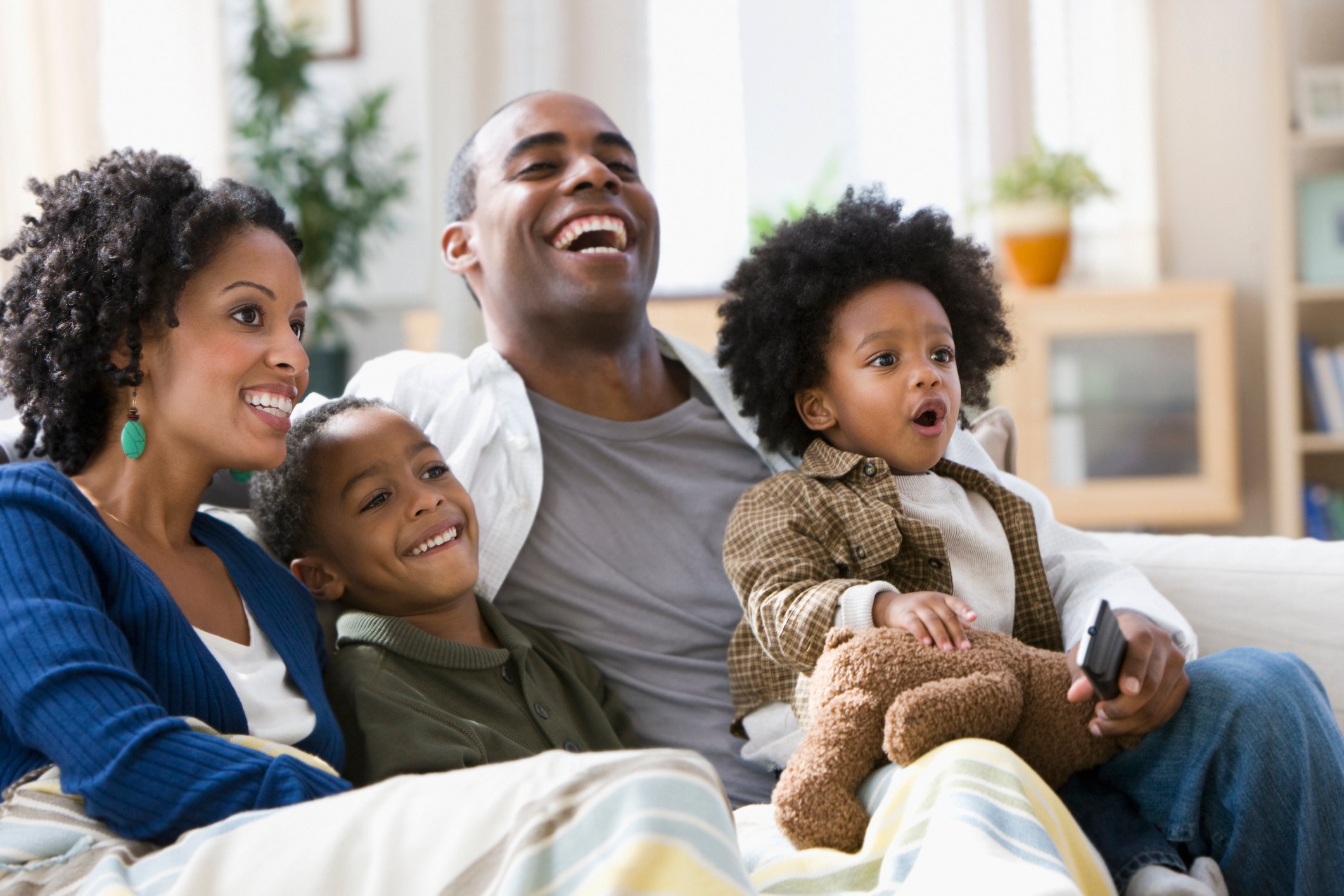 Young family watching television together.