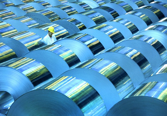 A worker among aluminum rolls. 