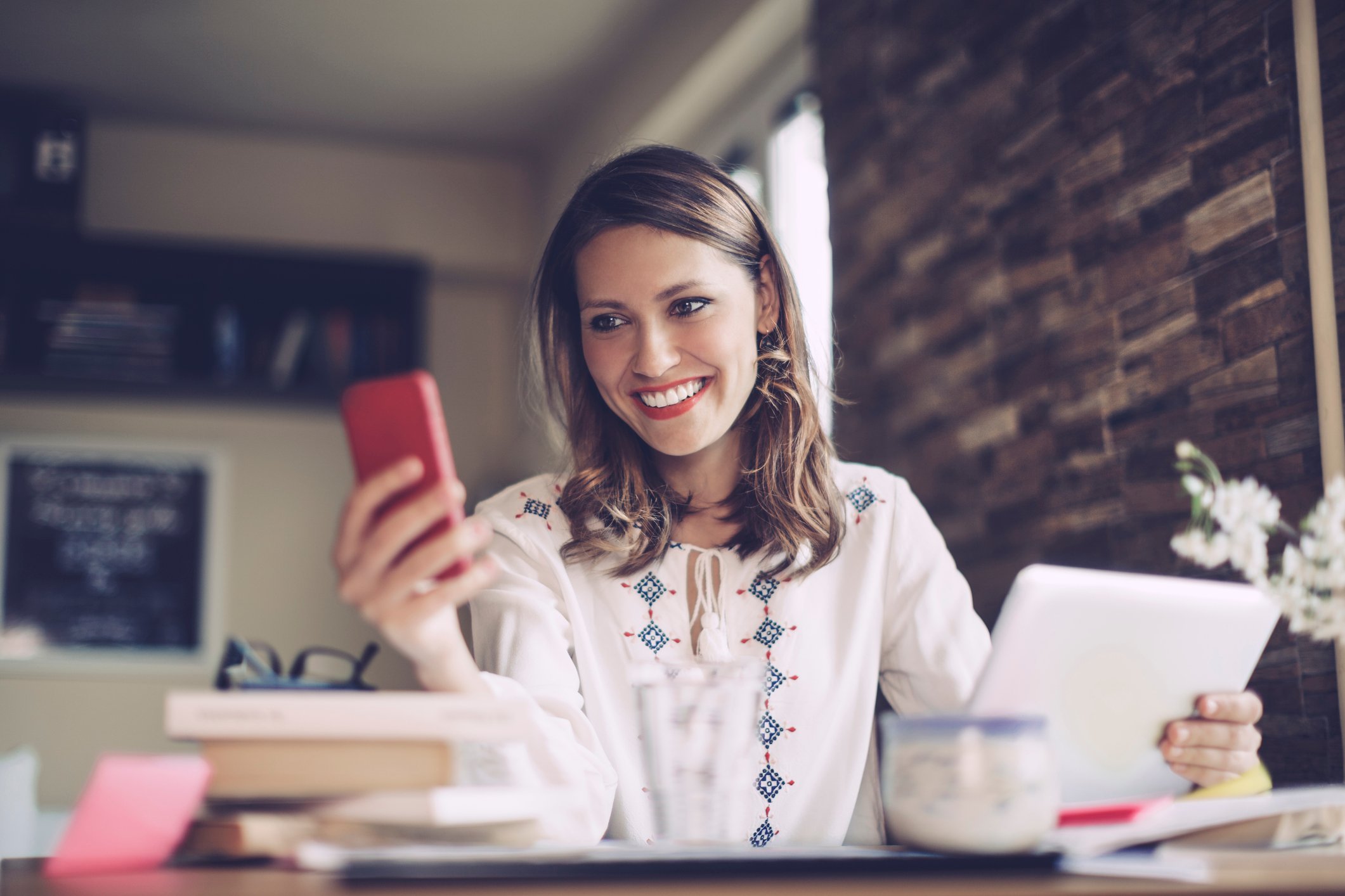 Person sitting at a desk looking at a phone