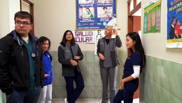 Five medical professionals wearing various types of FIGS scrubs.