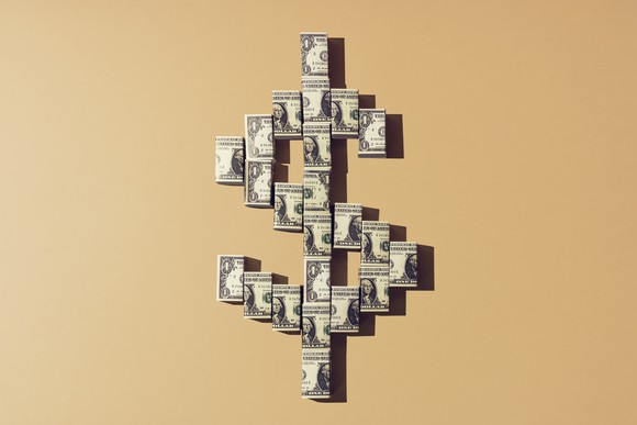 Big dollar sign made up of dollar bills.