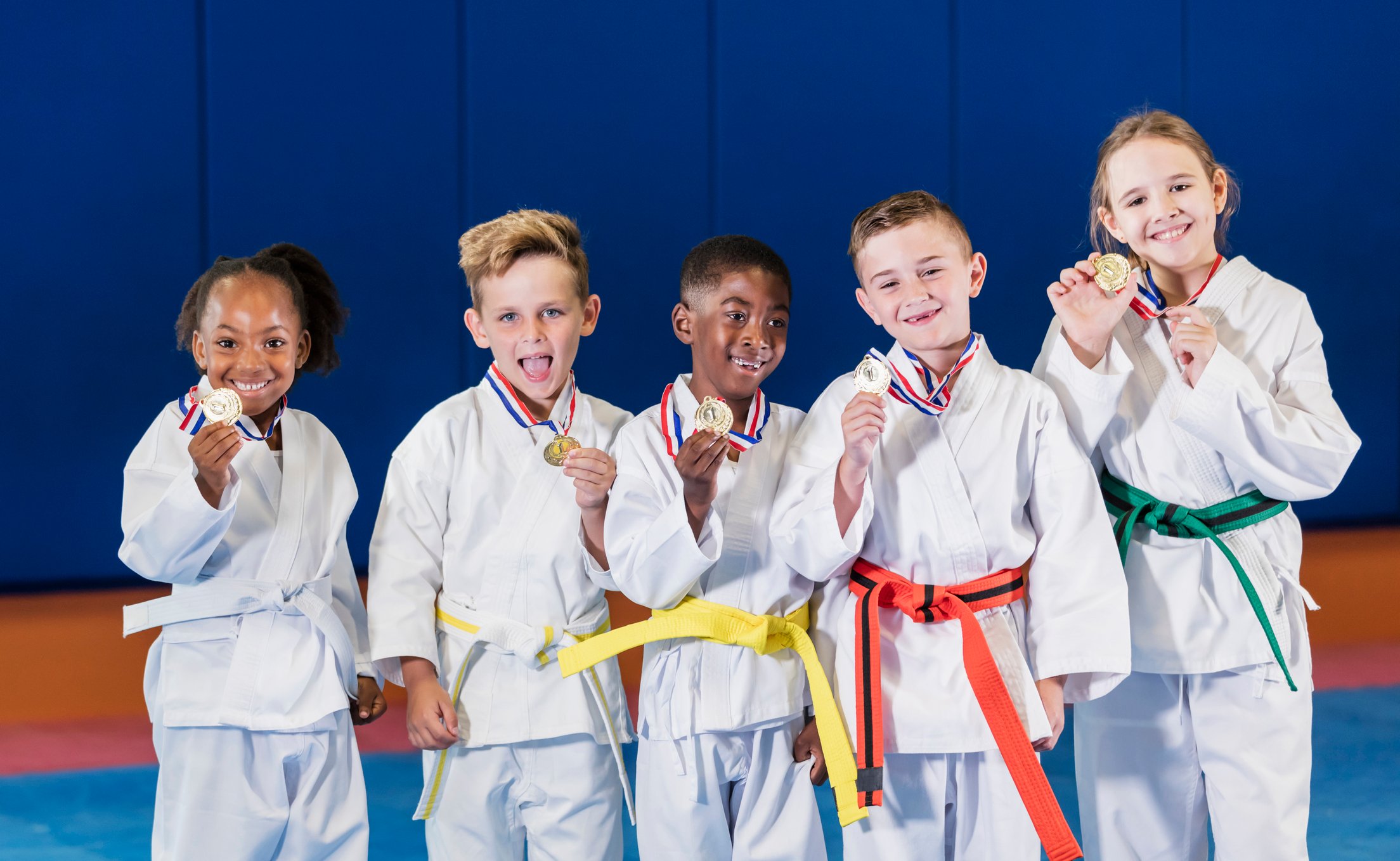 5 children showing off their medals.