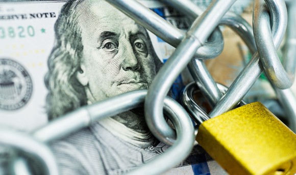 $100 bill with a chain and lock.