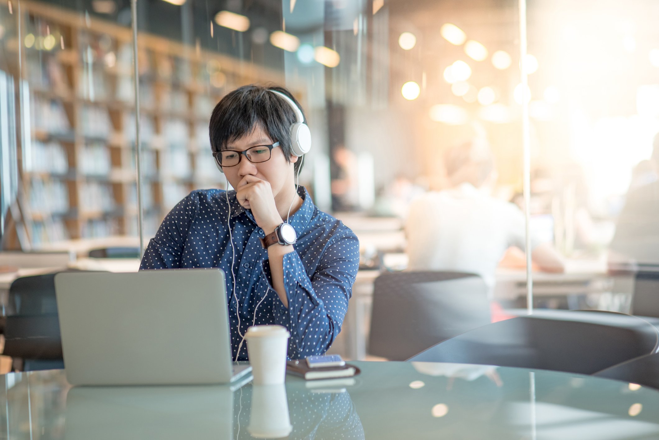Person with headphones looking at laptop